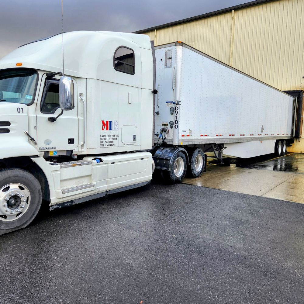 MIR Freight Mack tractor and 53-foot dry van trailer at a loading dock